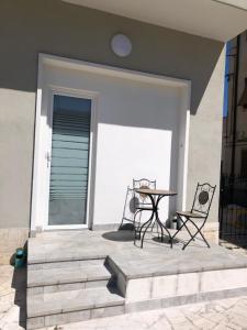 a patio with a table and chairs on a house at La Tana de Il Lupo e La Volpe in Centobuchi