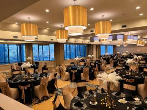 a banquet hall with tables and chairs and chandeliers at Crowne Plaza Princeton - Conference Center by IHG in Princeton