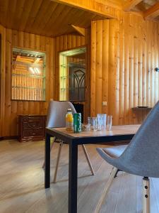 a table and chairs in a room with wooden walls at Castle Apartments in Schaslyve