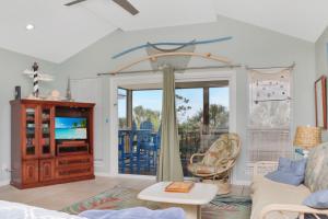 a living room with a couch and a tv at Gulfside GEM by Pristine Properties Vacation Rentals in Indian Pass