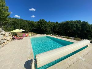a swimming pool with a bench next to at Villa les Jules in Thoard