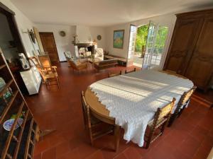 a living room with a table with a white blanket on it at Villa les Jules in Thoard