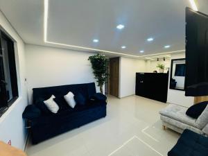 a living room with a couch and a chair at Aero Hotel in Bogotá +35 photos