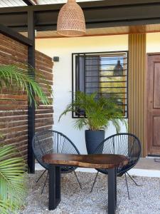 two chairs and a table in front of a house at Apartamento 2, cerca de la playa, naturaleza y paz in Santa Cruz