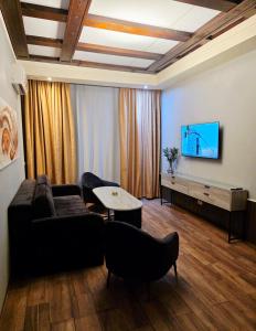 a living room with a couch and a flat screen tv at Hotel House in Rishon LeẔiyyon +37 photos
