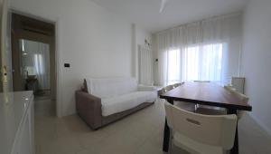 a living room with a couch and a table at Appartamenti Federica in Milano Marittima