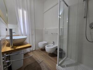 a bathroom with a sink and a toilet and a shower at Appartamenti Federica in Milano Marittima +10 photos