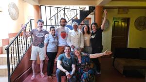 a group of people posing for a picture in a house at Cajanus Inn & Safaris in Karatu