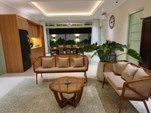 a living room with two couches and a table at Dalem Kamulyan Kraton in Timuran