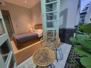 a bedroom with a bed and a table and a chair at Dalem Kamulyan Kraton in Timuran