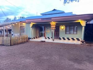 a building with a sign on the front of it at Cajanus Inn & Safaris in Karatu