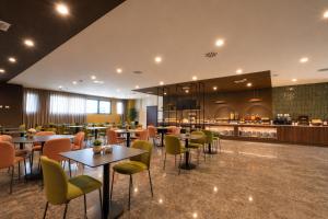 a restaurant with tables and chairs and a bar at LVG Hotel Collection - Belfiore in Mantova