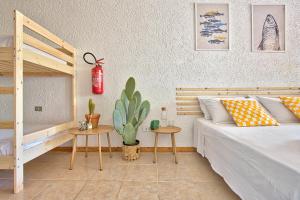 a bedroom with a bed and two tables and a cactus at Monolocale al centro della Costa Smeralda in Cugnana Verde +9 photos