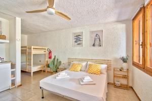 a living room with a bed and a bedroom at Monolocale al centro della Costa Smeralda in Cugnana Verde