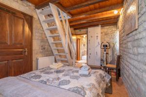 a bedroom with a bed in a room with stairs at Polilimnio Foteini's Mini Castle in Metamórfosis