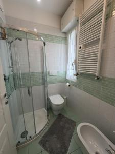 a bathroom with a shower and a toilet and a sink at Appartamenti Federica 5 in Milano Marittima +14 photos