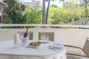 a table with a bottle of wine and a plate of food at Appartamenti Federica 5 in Milano Marittima