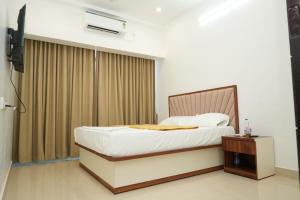 a bedroom with a bed and a window at Silver Sea in Patna