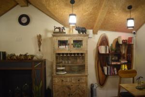 a room with a book shelf and a clock at Roots & Rustle homestay in Kūfrī