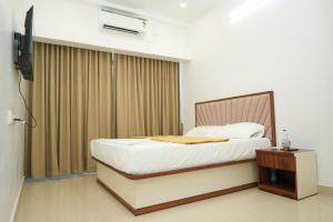a hotel room with a bed and a window at Silver Sea in Patna