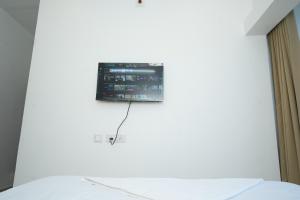 a television on the wall of a bedroom at Silver Sea in Patna