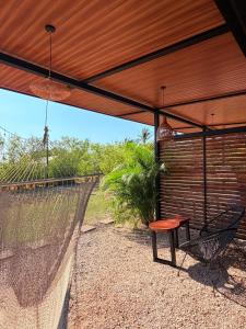 a patio with a table and a bench under a pergola at Apartamento 2, cerca de la playa, naturaleza y paz in Santa Cruz +33 photos