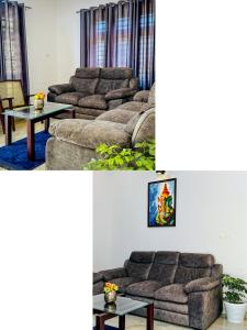 a living room with two couches and a table at CloudNine Stay in Sultan Bathery