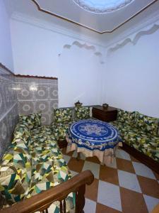 a room with two beds and a table in it at Central Private Haven in Martil