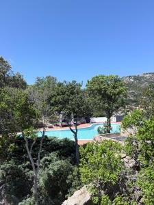 a view of a swimming pool with trees at Villa Esmerea Portocervo con Piscina privata ,Jacuzi e Sauna in Porto Cervo