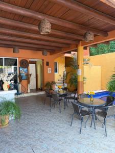 an outdoor patio with tables and chairs and awning at Hotel Las Salinas in Zihuatanejo