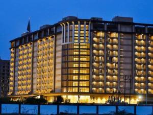 a large building with many windows at night at Weekend address in Surat