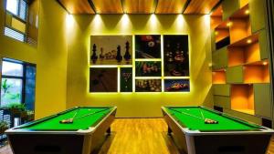 a billiard room with two pool tables in it at Weekend address in Surat