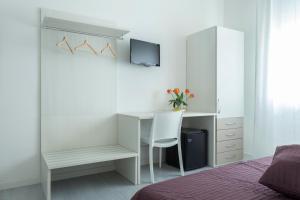 a bedroom with a desk with a chair and a computer at Easy Venice Rooms 1- 2 in Mestre
