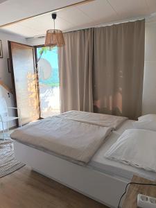 a bedroom with a large bed with a large window at Studio apartman Belvedere in Motovun