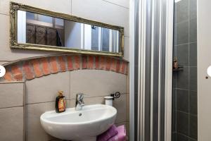 a bathroom with a sink and a mirror at Charming LUCCA in Lucca