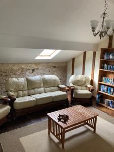 a living room with a couch and a coffee table at Le Chene Vert in Millac