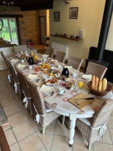 a long table with food on top of it at Le Chene Vert in Millac