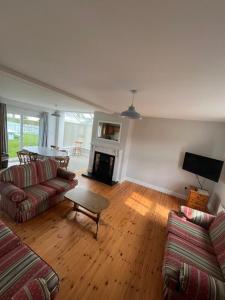 a living room with two couches and a fireplace at Rougey Lodge Hostel in Bundoran