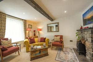 a living room with a couch and chairs and a fireplace at 2 Bed in Kingsteignton oc-w34194 in Kingsteignton