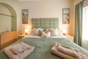 a bedroom with a large bed with two towels on it at 2 Bed in Kingsteignton oc-w34194 in Kingsteignton