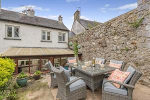 a patio with a table and chairs and a building at 2 Bed in Kingsteignton oc-w34194 in Kingsteignton