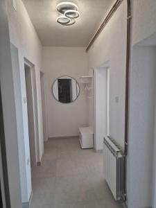 a hallway with a round mirror and a bathroom at Guest House Perla in Sveti Juraj +188 photos
