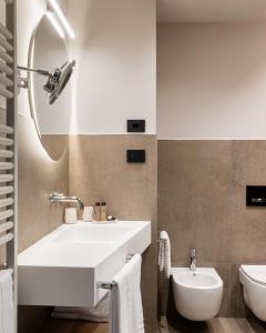 a bathroom with a white sink and a toilet at Agriturismo Vedova in Valdobbiadene +65 photos