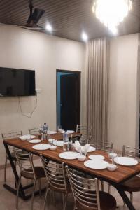 a conference room with a large wooden table and chairs at The Whistling Pine Homestay With Natural Swimming Pool in Lansdowne