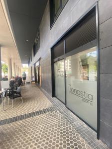a front door of a store with chairs and tables at Donosti rooms in Loyola
