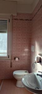 a bathroom with a toilet and a sink and a tub at Hotel Anita B&B sul lungomare in Gatteo a Mare +51 photos