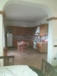 a kitchen with a table and chairs and a dining room at Bellavista Coghinas in Oschiri