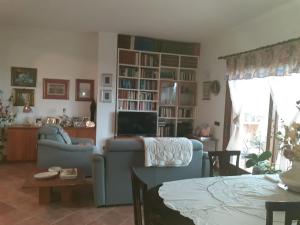 a living room with a couch and a tv at Bellavista Coghinas in Oschiri