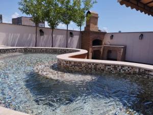a swimming pool with a fountain in a house at Avangard Hotel in Yerevan
