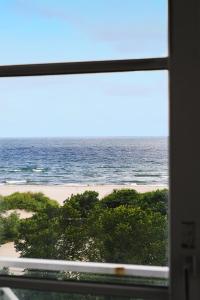 a view of the beach from a window at CORI Hornbæk Hotel in Hornbæk